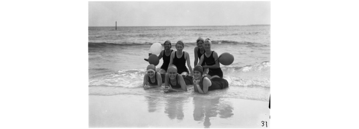 Group of swimmers enjoying the beach on the Isle of Caprice