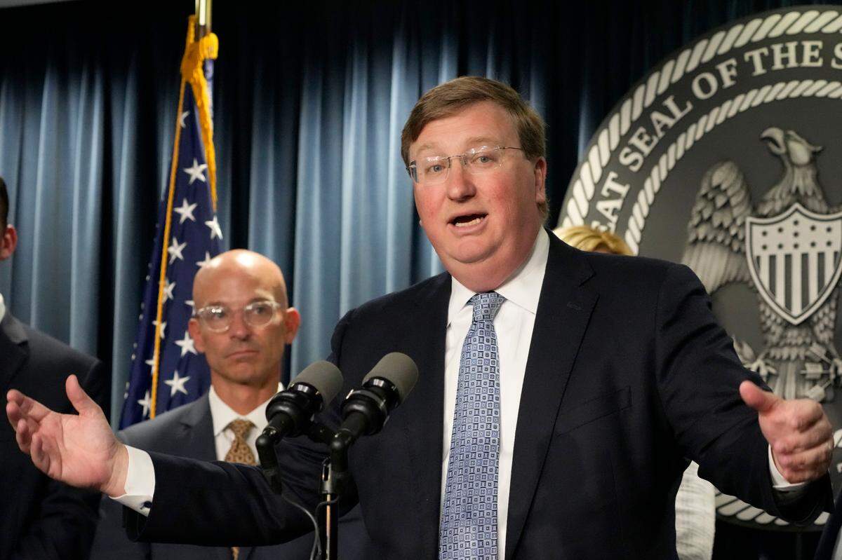 Mississippi Gov. Tate Reeves, right, announces a proposal that he says should alleviate financial problems for hospitals, during a news conference Thursday, Sept. 21, 2023, in Jackson, Miss. Associate Vice Chancellor for Clinical Affairs at the University of Mississippi Medical Center Dr. Alan Jones listens at left. (AP Photo/Rogelio V. Solis)