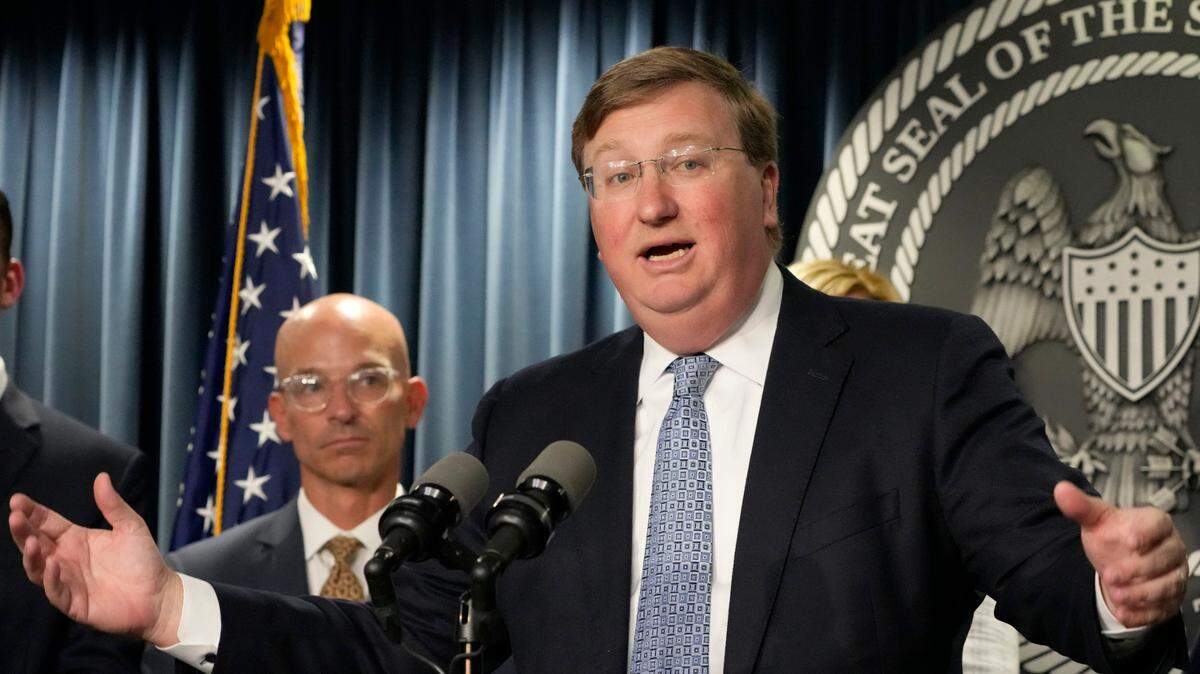 Mississippi Gov. Tate Reeves, right, announces a proposal that he says should alleviate financial problems for hospitals, during a news conference Thursday, Sept. 21, 2023, in Jackson, Miss. Associate Vice Chancellor for Clinical Affairs at the University of Mississippi Medical Center Dr. Alan Jones listens at left. (AP Photo/Rogelio V. Solis)