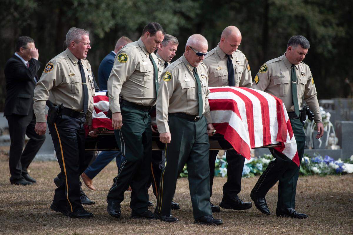 Members of law enforcement carry the casket of George County Sheriff’s Deputy Jeremy Malone to the grave site at Tanner Cemetery following Malone’s funeral at Agricola Baptist Church in George County on Friday, Jan. 12, 2024. Malone was shot and killed while conducting a traffic stop on Jan. 4.