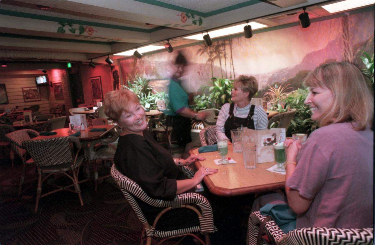 Patrons of Bombay Bicycle Club joke together during a late afternoon break.