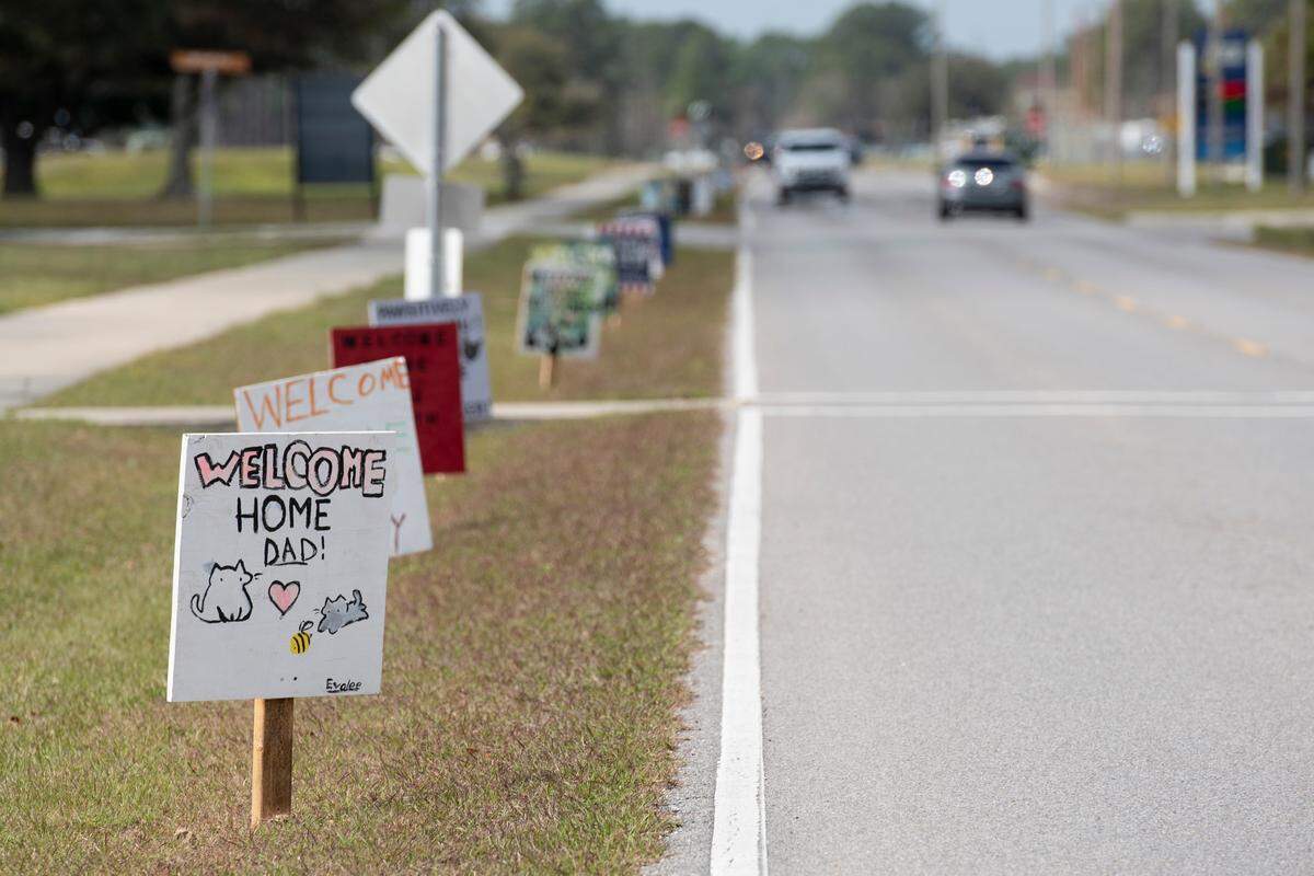 Signs line the roads at Naval Construction Battalion Center Gulfport welcoming home members of Naval Mobile Construction Battalion 1 as they return home from deployment on Thursday, March 13, 2025.