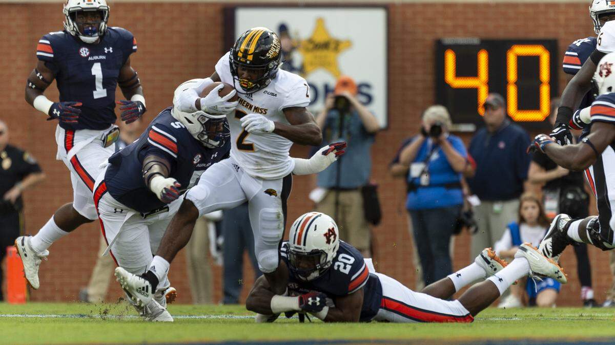 Southern Miss wide receiver Jaylond Adams (2) is pursued by Auburn defensive lineman Derrick Brown (5) and Auburn defensive back Jeremiah Dinson (20) during the first half of an NCAA college football game, Saturday, Sept. 29, 2018, in Auburn, Ala. (AP Photo/Vasha Hunt)