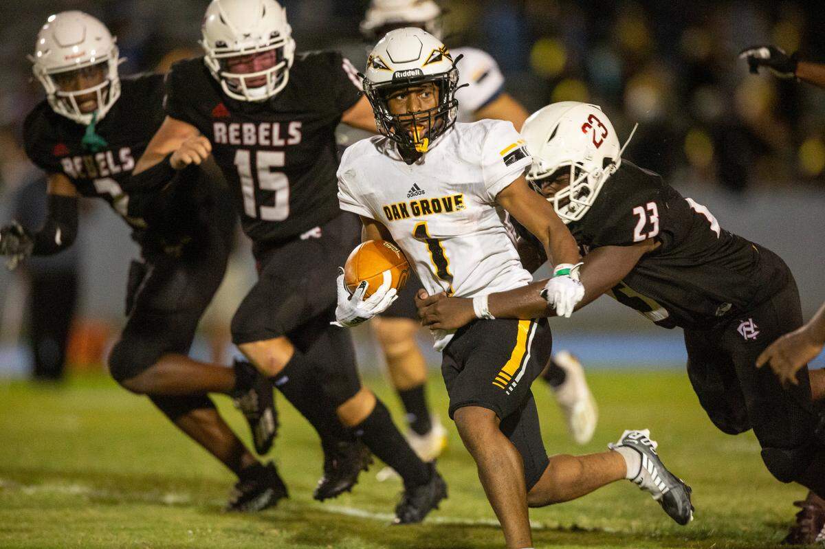 Oak Grove’s JQ Gray gets tackled by Harrison Central’s Boone Wilson during a game against Harrison Central at Milner Stadium in Gulfport on Friday, Aug. 26, 2022.