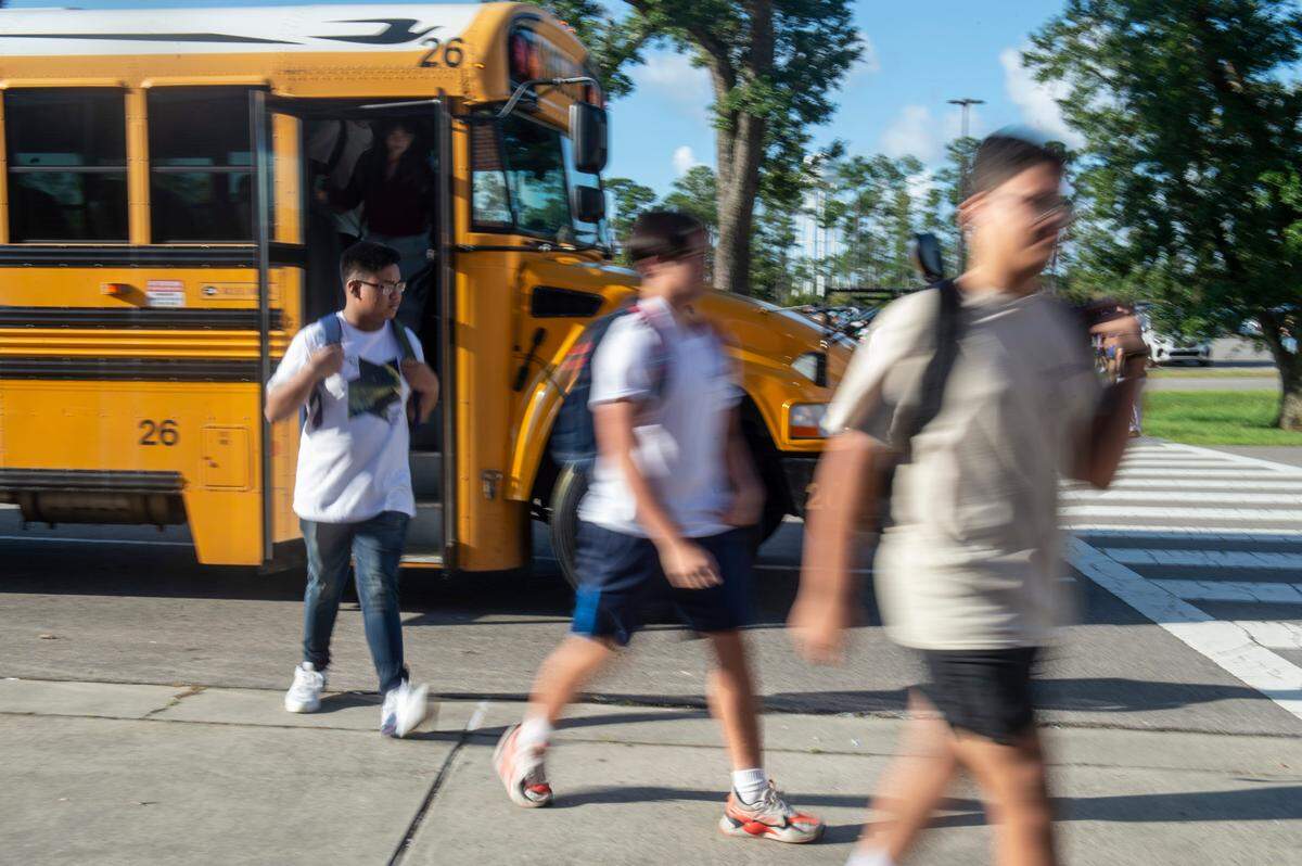 High school students are let off the bus for their first day of classes at Ocean Springs High School in Ocean Springs on Friday, Aug. 5, 2022.