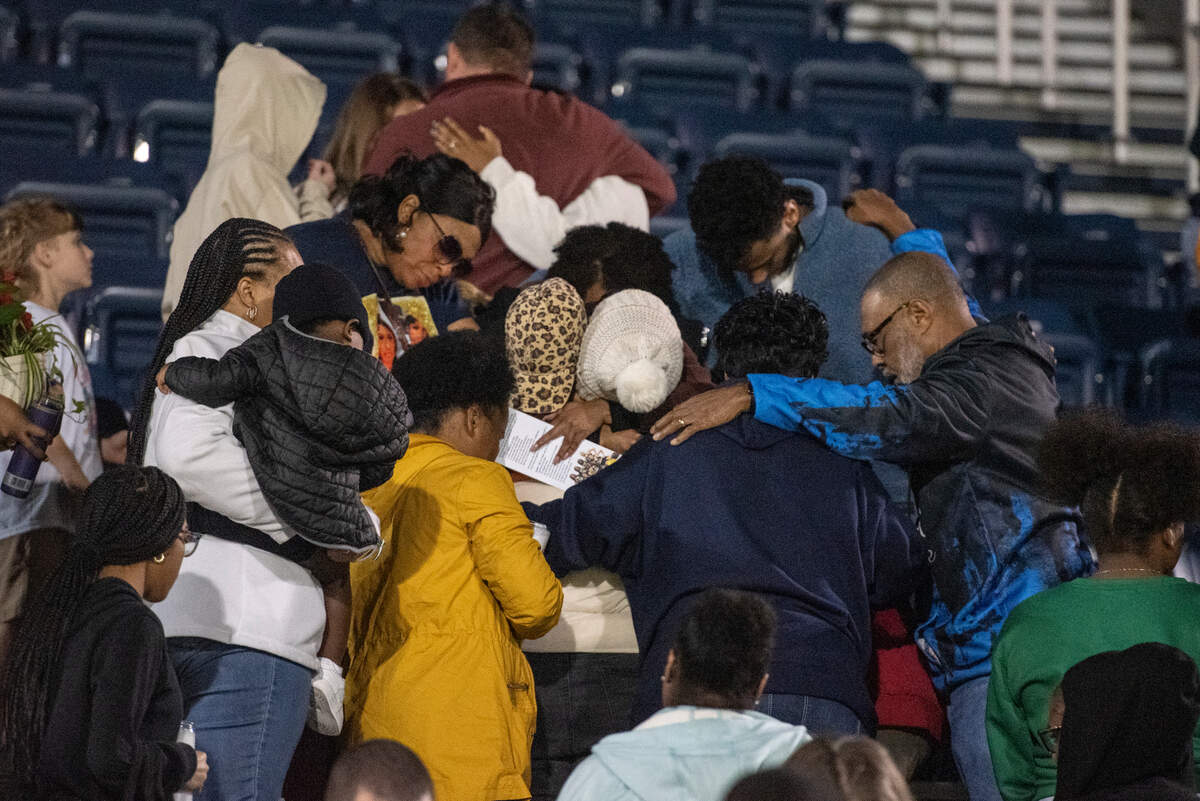Family, friends and community members pray together after a candlelight vigil in honor of three Gautier High School graduates at Gautier High School in Gautier on Thursday, Dec. 7, 2023. Se’Dhari Saniya Watson-Person, Kyla “Muffin” Watkins, and Tatyanna Richmond were involved in a fatal crash on Tuesday, leading to the deaths of Watson-Person and Watkins. Richmond remains hospitalized.