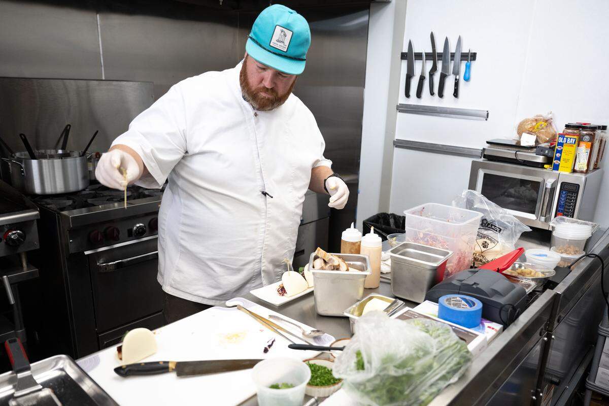 Chef Austin Sumrall plates Korean pork belly sliders at Chandeleur Depot Brewpub in Pascagoula. The new restaurant is right next to the Amtrak platform.