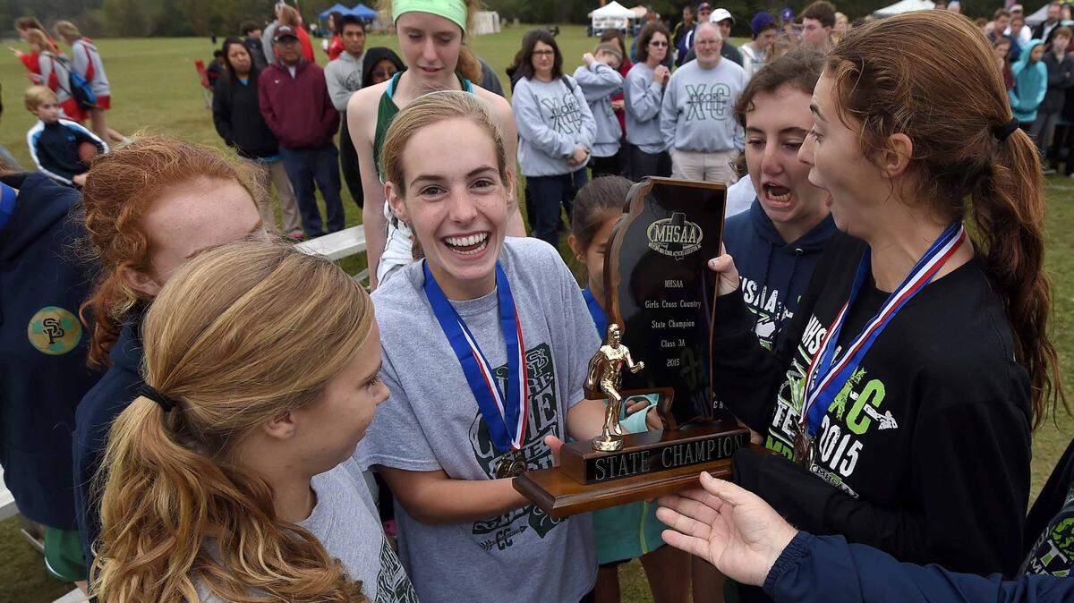 CHRIS TODD/SPECIAL TO THE SUN HERALD 
 St. Patrick's Ramsey Wagner (center) and the Lady Irish are all smiles after winning the girls Class 3A title in the MHSAA State Cross Country Championships at Choctaw Trails in Clinton on Monday.
