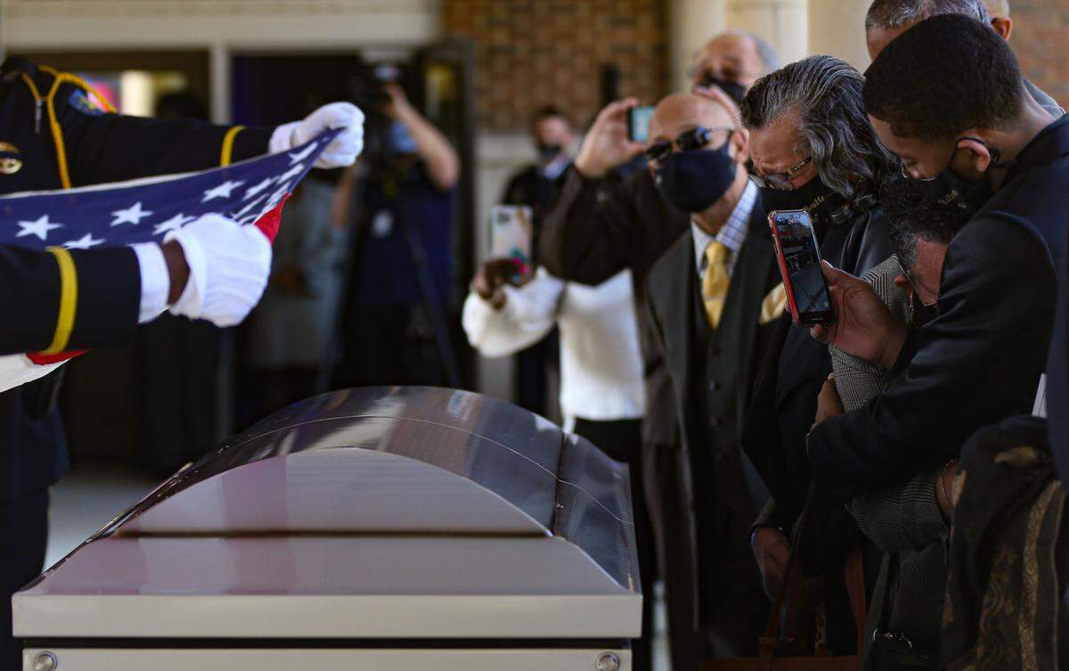 Family and loved ones grieve over the casket of fallen Hancock County Deputy Lt. Michael Boutte as the flag from his casket is folded to be presented to the family Tuesday, February 9, 2020 in Hancock County, Miss.