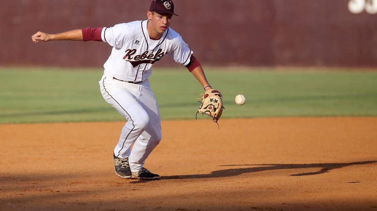 AMANDA McCOY/SUN HERALD 
 George County shortstop Brycen Scott scrambles to recover a ground ball while competing against Petal in the opening game of the Class 6A South State series on Thursday, May 12, 2016.