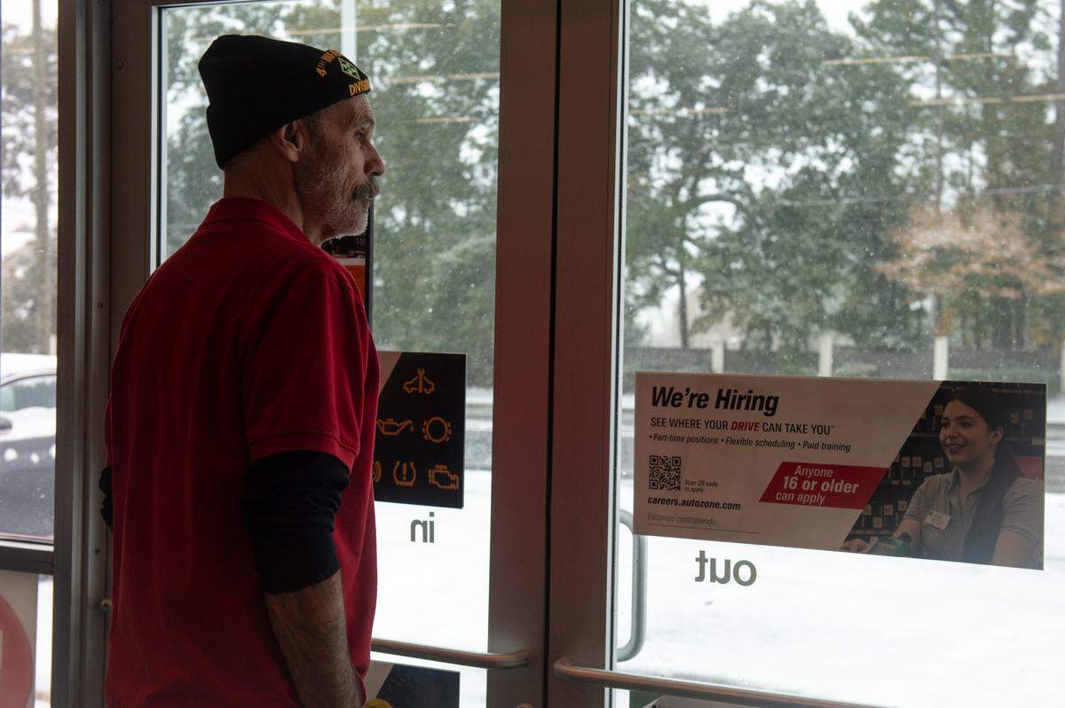 AutoZone employees watch as snow accumulates in Ocean Springs on Tuesday, Jan. 21, 2025. The store was one of only a few businesses open.