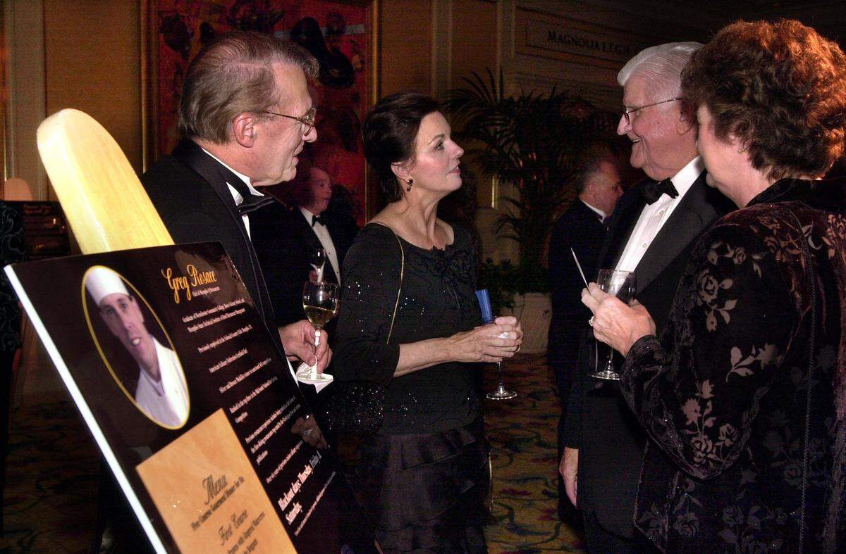 Gene Warr and his wife, Kay, left, talk with Jerry O’Keefe and his wife, Martha, while looking over a chef’s menu on display at the Center Circle Ball at the Beau Rivage Casino in Biloxi on in 2001.