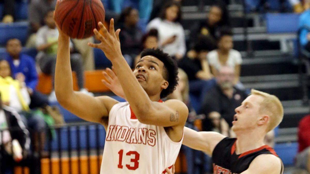 AMANDA McCOY/SUN HERALD 
 Biloxi's Fred Ramsey-Thompson takes a shot while guarded by Metamora's Noah Persich during the Gulfport Hardwood Holiday Classic on December 29. He was selected to the Mississippi Association of Coaches All-Star Game in Clinton on Friday.