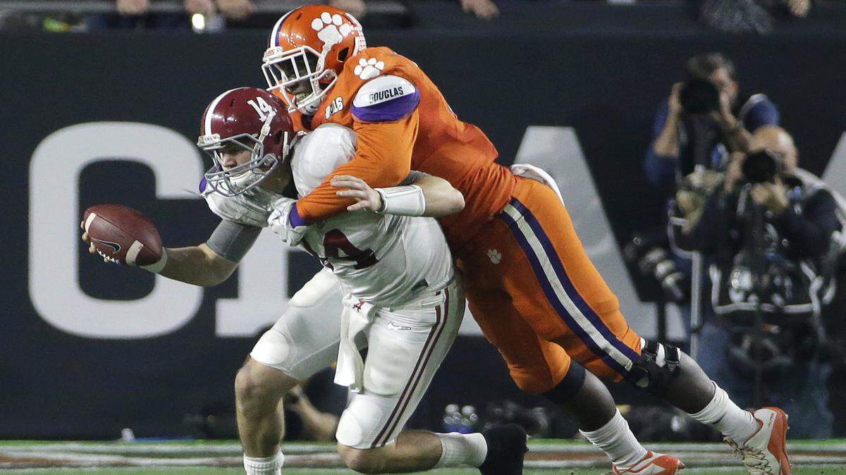 Clemson's Shaq Lawson, right, sacks Alabama's Jake Coker during the first half of the NCAA college football playoff championship game Monday, Jan. 11, 2016, in Glendale, Ariz. (AP Photo/David J. Phillip)