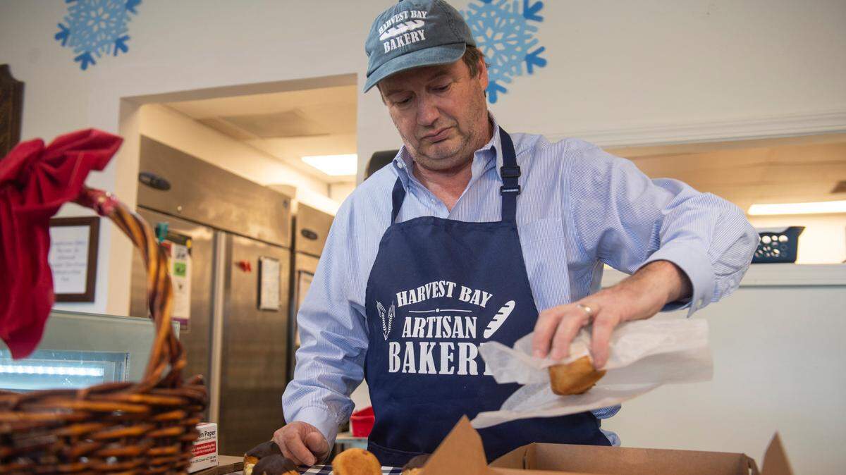 Owner Alex Lacy packs an order of eclairs for a customer at Harvest Bay Artisan Bakery in Bay St. Louis on Thursday, Dec. 7, 2023.