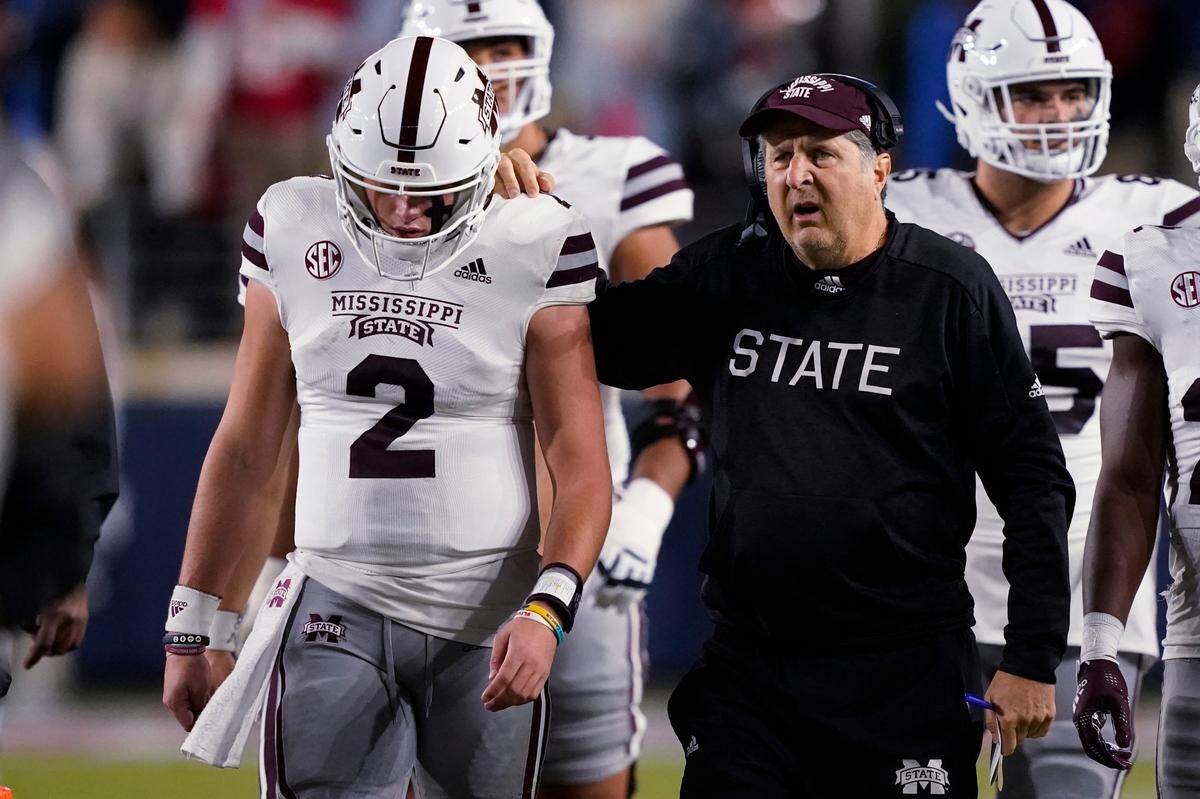 Mississippi State coach Mike Leach confers with quarterback Will Rogers (2) during the first half of the team’s NCAA college football game against Mississippi in Oxford, Miss., Thursday, Nov. 24, 2022. (AP Photo/Rogelio V. Solis)