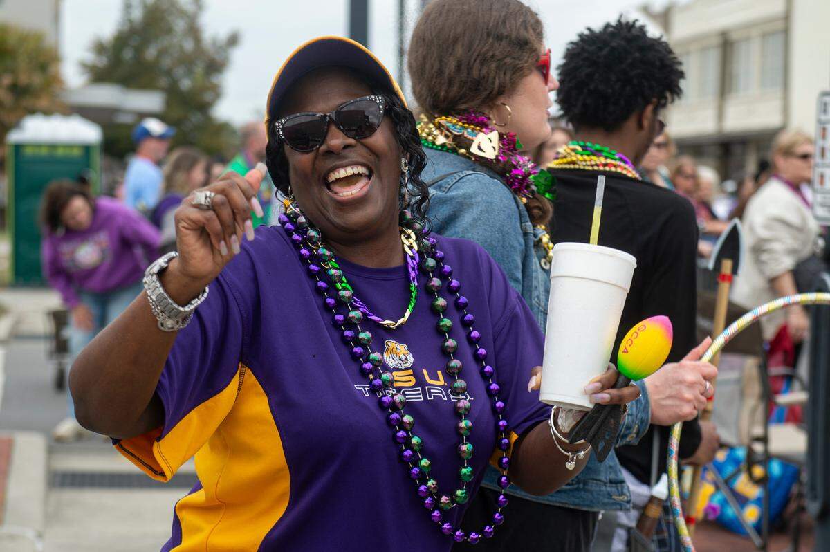 A paradegoer dances during the Krewe of Gemini parade in downtown Gulfport on Saturday, Feb. 10, 2024.