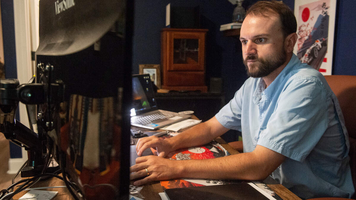 Christian Braswell works at his home office in Gulfport on Friday, May 23, 2025. Remote work allowed Braswell, who works remotely doing web development for a company called Fruition, to move back to Mississippi from Colorado with his wife.
