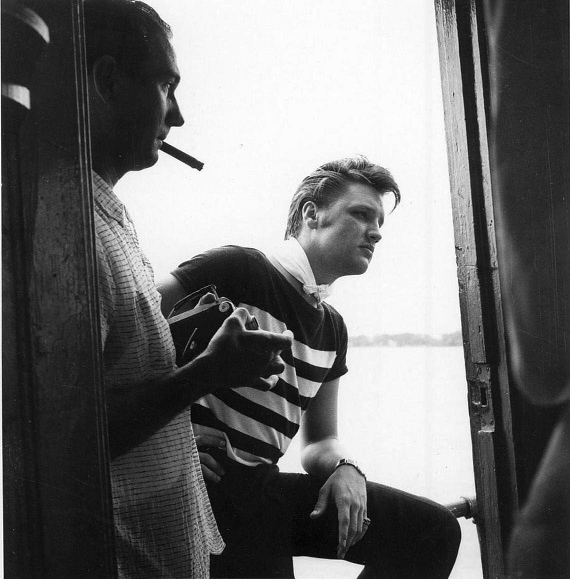 Elvis Presley in Biloxi aboard the deep sea fishing charter boat Aunt Jennie on July 12, 1956, just after a big shark broke his line. Biloxi business man Eddie Bellman smokes a cigar and holds the movie camera with which he took rare film footage of the up-and-coming star. Mississippi Gulf Coast Community College C.C. “Tex” Hamill Down South Magazine Collection.