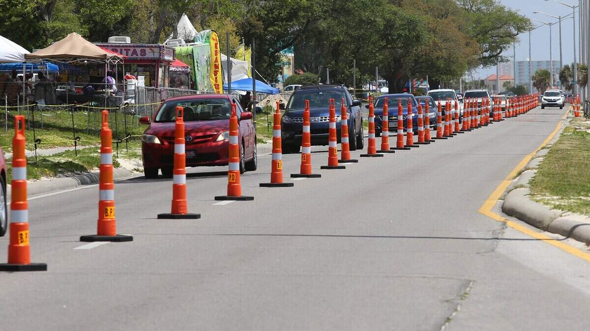 Motorists make their way down U.S. 90 in Biloxi on Friday, April 13, 2018. Police used orange cones to separate emergency and civilian traffic during Black Spring Break.