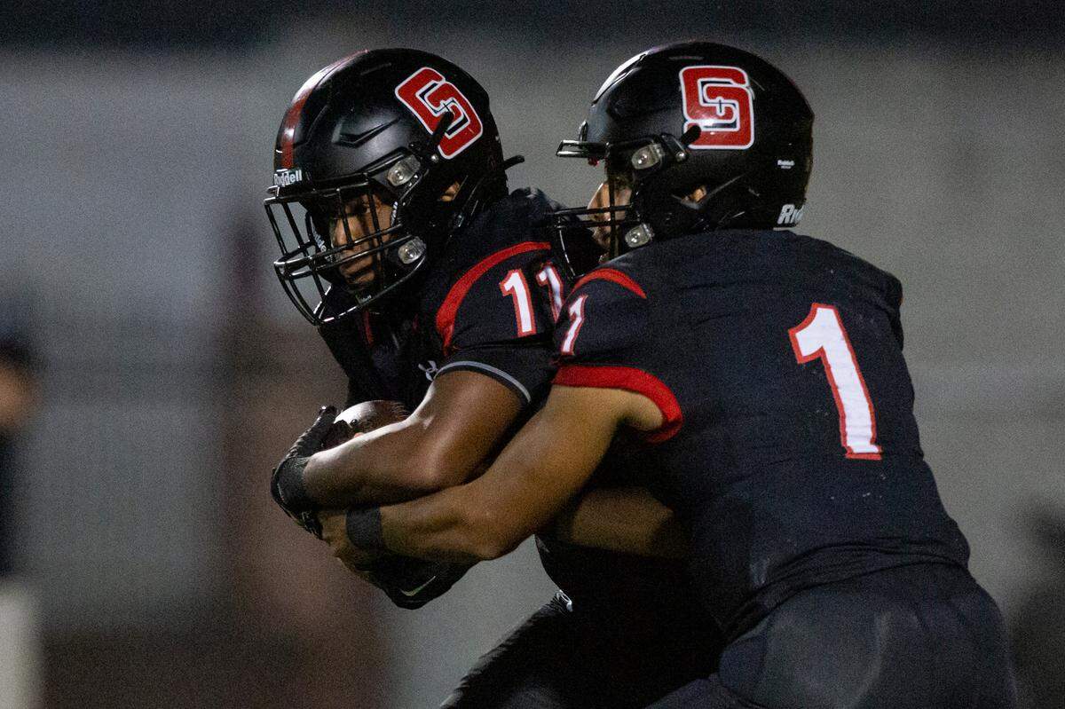 St. Stanislaus’ quarterback Ian Gonzales Rioz passes the ball off to Isaiah Haynes during a game against the Stone Tomcats at St. Stanislaus High School in Bay St. Louis on Friday, Sept. 29, 2023.