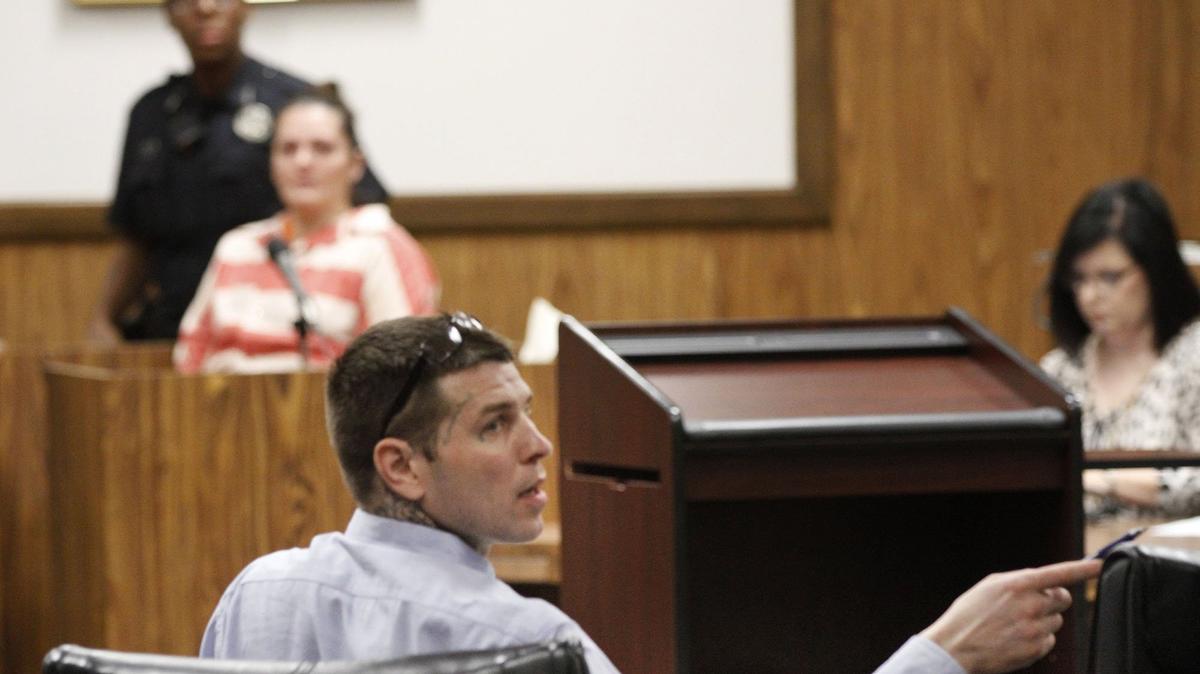 Joshua Peterman, foreground, talks to his attorney during his trial on a first-degree murder charge in Harrison County Circuit Court in Gulfport as witness Kari Parker sits on the stand. Peterman is accused of killing Tena Marie Broadus in September 2015. Parker has pleaded guilty to second-degree murder in the case.