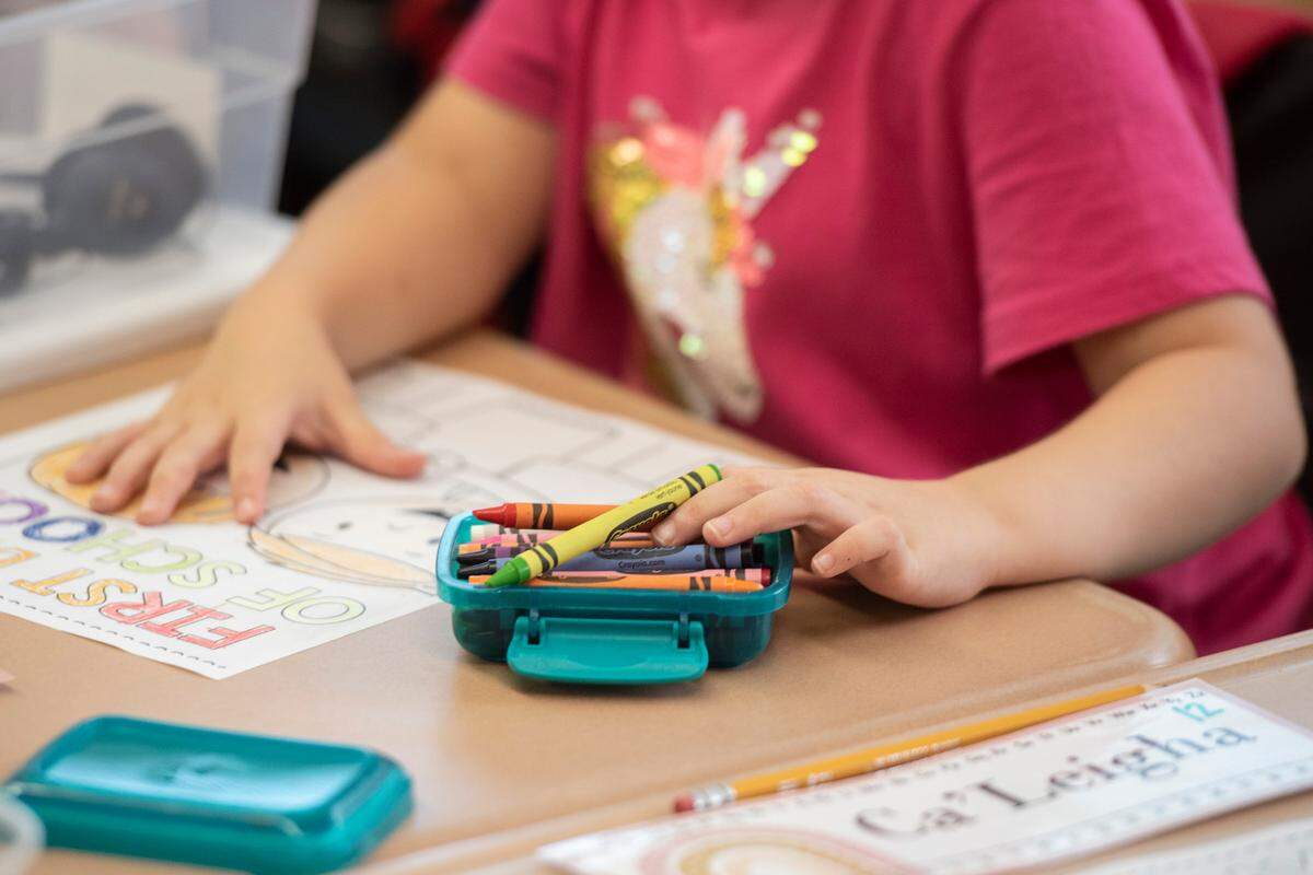 Elementary school students color in coloring sheets on the first day of school at Magnolia Park Elementary on Friday, Aug. 5, 2022.
