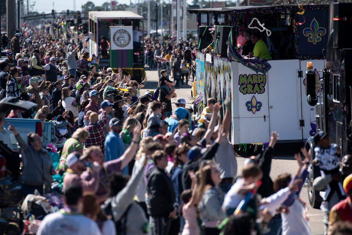 Krewe members toss beads to the crowd during the Krewe of Nereids Mardi Gras parade on Highway 90 in Bay St. Louis on Sunday, Feb. 12, 2023.