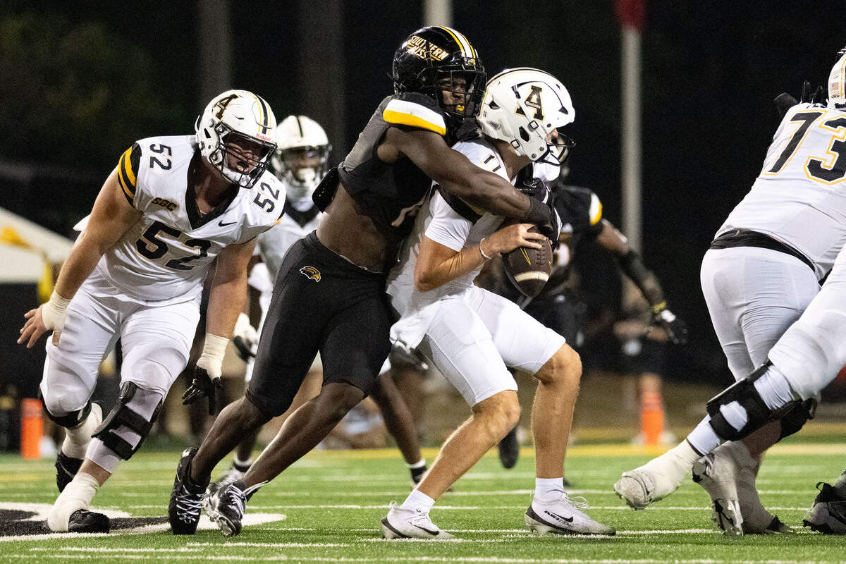 Southern Miss defensive lineman J'Mond Tapp (14) sacks Appalachian State quarterback Noah Gillon (11) during a football game at M. M. Roberts Stadium on Saturday, Sept. 13, 2025. The Golden Eagles won 38-22.