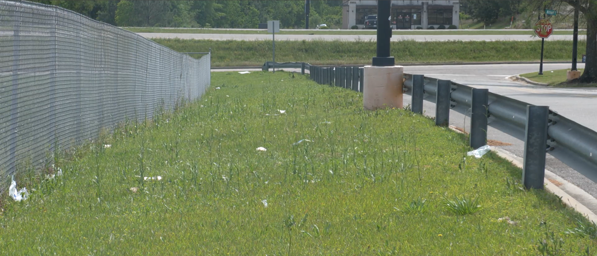 Litter is visible along the fence line near a Walmart in Wiggins. The Mississippi Department of Transportation says the state’s rural litter rate is 30% higher than the national average.