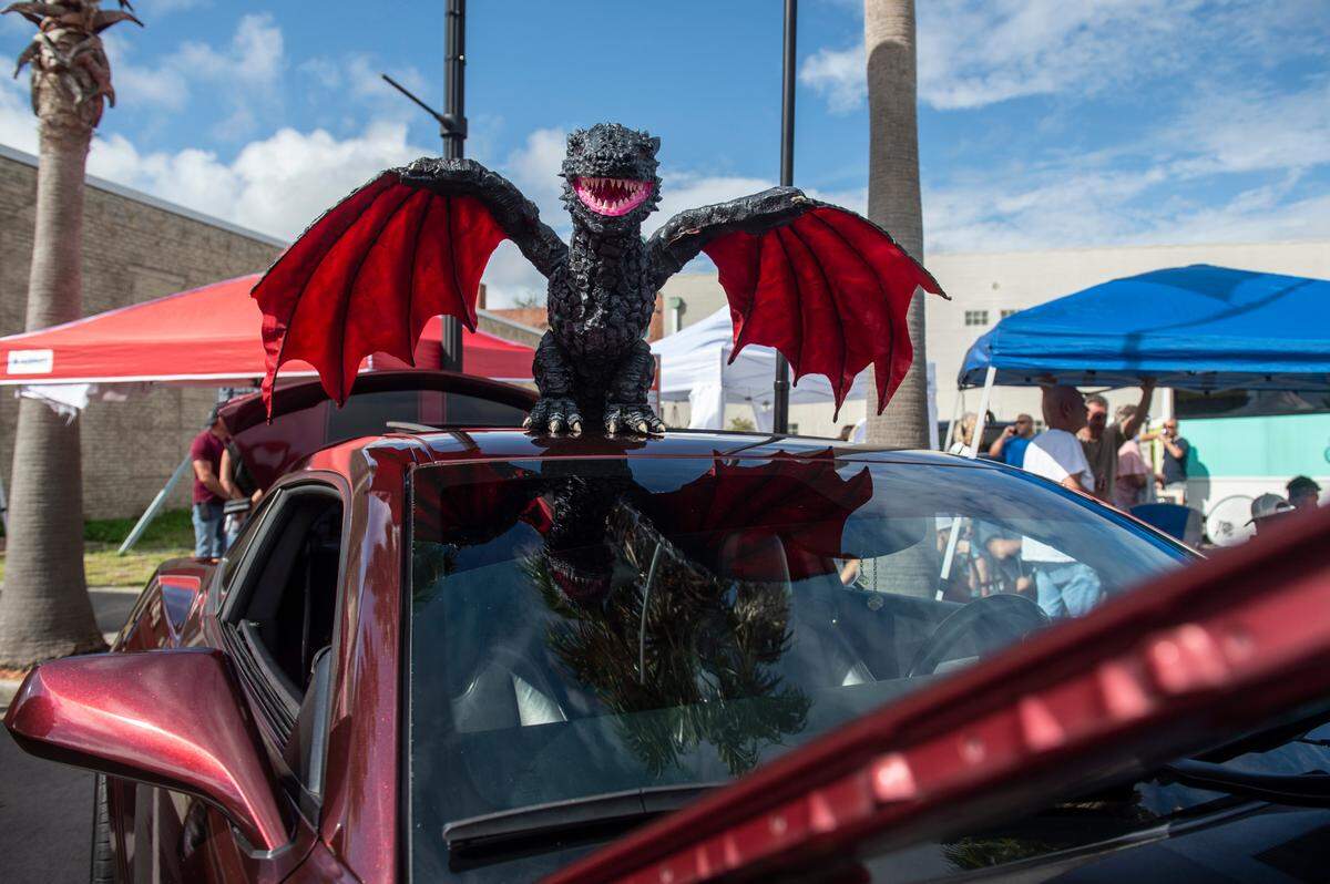 A dragon perches on top of a Game of Thrones themed car during View the Cruise in downtown Gulfport on Sunday, Oct. 3, 2021.