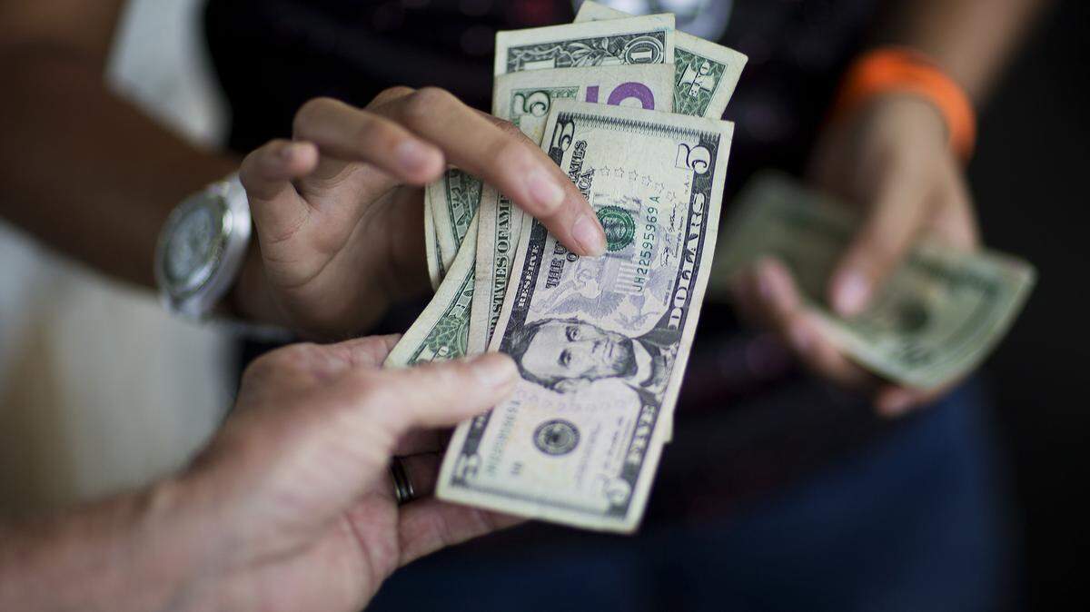DAVID GOLDMAN/ASSOCIATED PRESSA customer pays for goods while shopping at the Atlanta Farmers Market in June.
