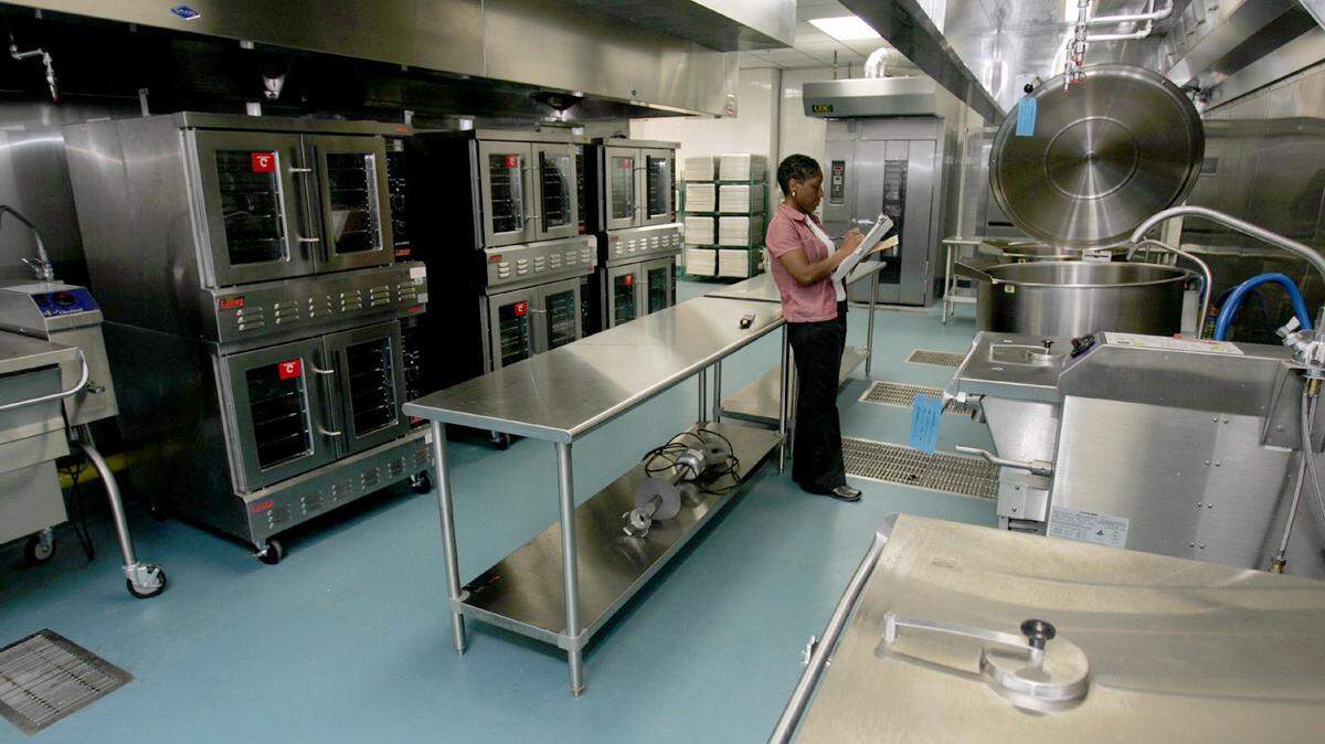 SUN HERALD FILE 
 Health Department inspector LaTanya Winn looks over the kitchen equipment at the Mississippi Coast Coliseum and Convention Center in Biloxi. Offices were closed and staff was cut this year after the Health Department's budget was slashed by Gov. Phil Bryant.
