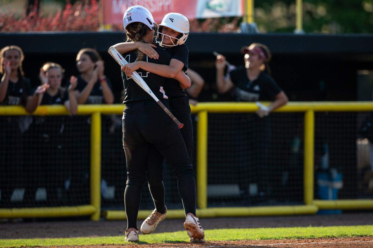 George County Lady Rebels’ Sidnee Beech hugs her teammate after a play during the 5A 2023 MHSAA Softball Championship game at USM Softball Complex in Hattiesburg on Thursday, May 18, 2023.