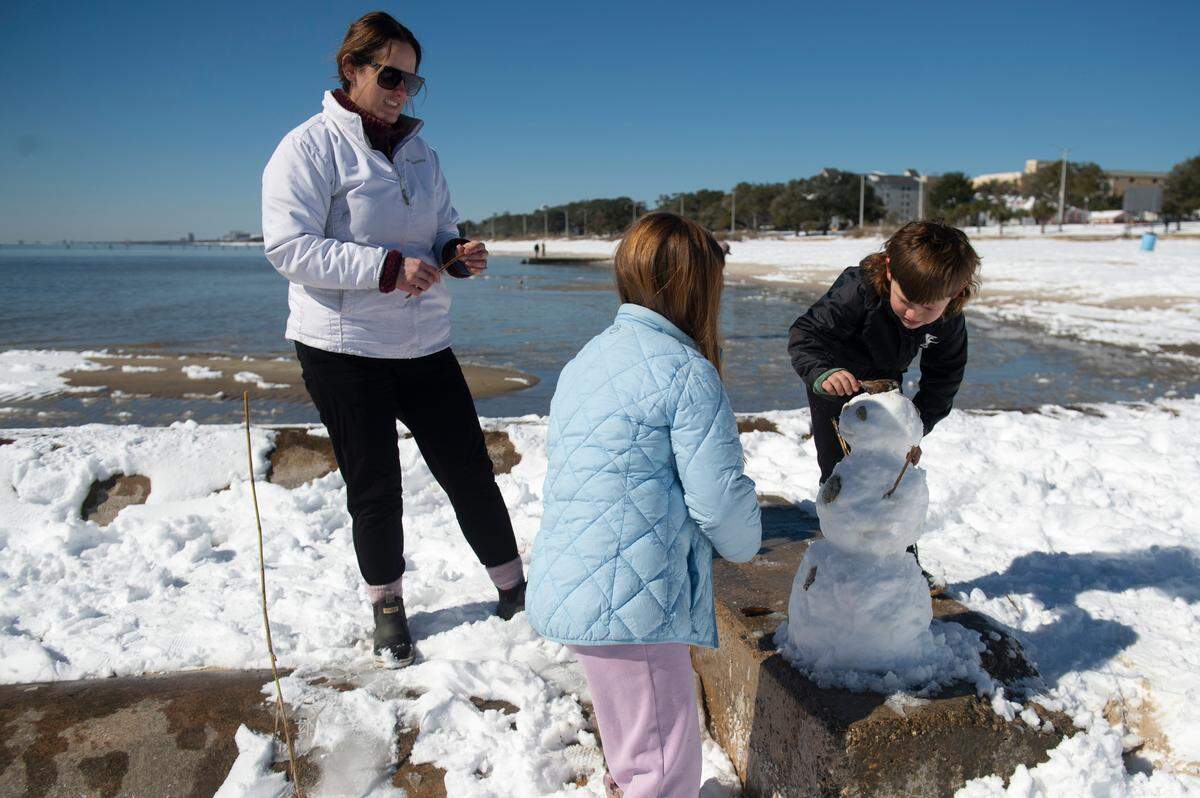 The Orman family (Erica, Michael, Lakelynn and Wesley), built a snowman Wednesday, Jan. 22, 2025, on Biloxi Beach.