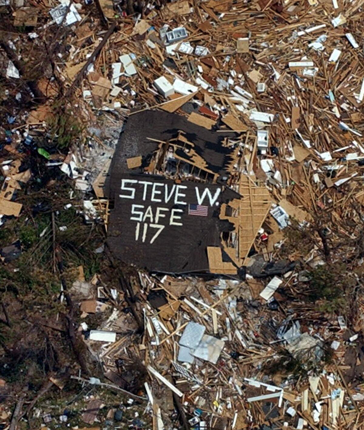A Hurricane Katrina survivor wanted to let his relatives know he was safe in Pass Christian on Wednesday, August 31, 2005. This neighborhood was a total loss from high winds and flood surge from Hurricane Katrina, as seen in this aerial photograph.