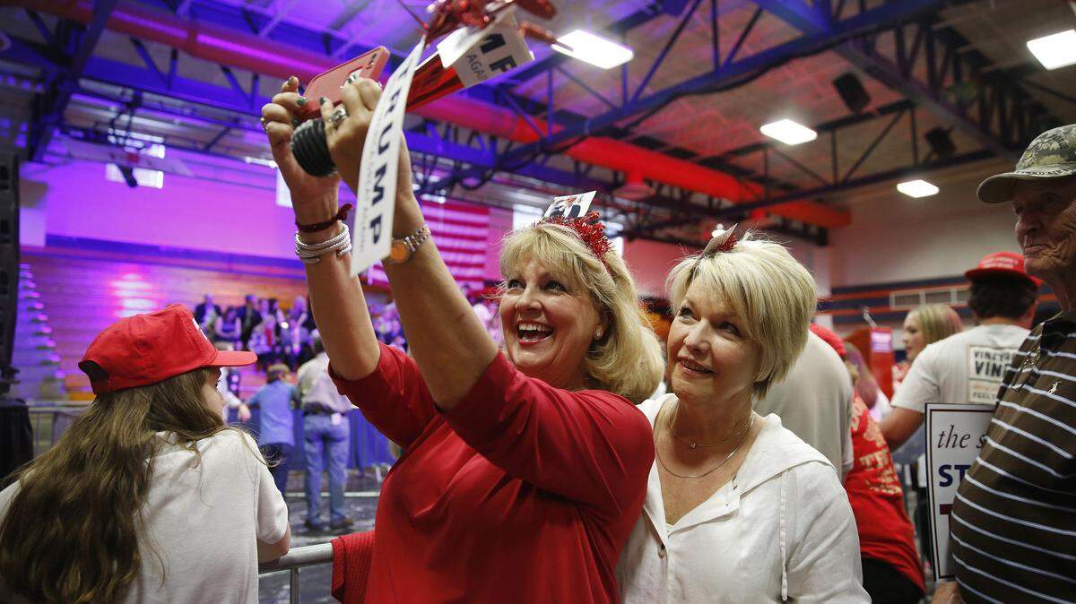 Supporters Donna Hild Russell, left, takes a selfie with Kay Little, right, before Republican presidential candidate Donald Trump speaks at campaign rally Monday, March 7, 2016, in Madison, Miss. (AP Photo/Brynn Anderson)