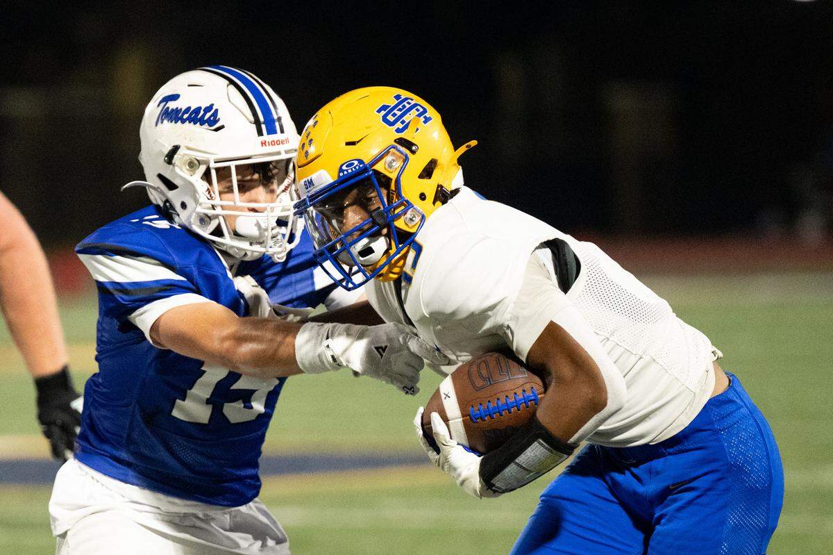 St. Martin running back Brayden Wells (15) sheds a tackle during the Yellow Jackets’ victory over Stone.
