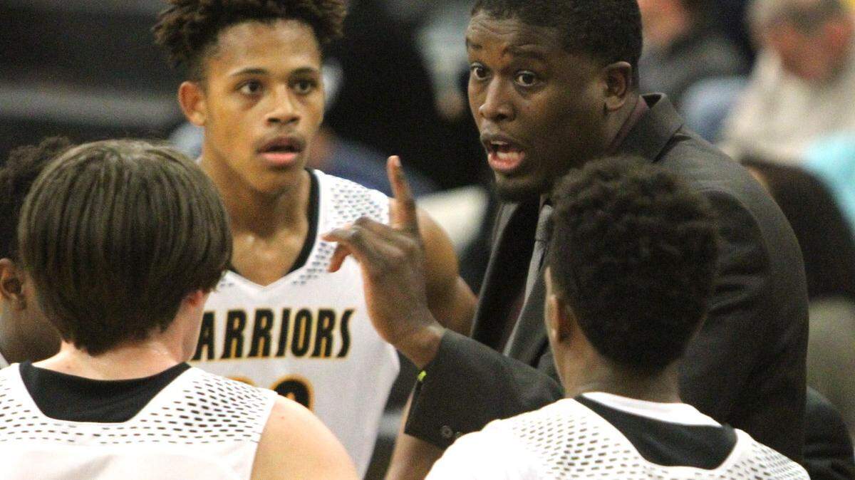 JOHN FITZHUGH/SUN HERALD 
 D'Iberville's head coach Lorenzo Wright talks to his players during a timeout of their game against St. Martin on Friday Jan. 8, 2016. The Warriors remained atop the latest Sun Herald boys top 10 poll.