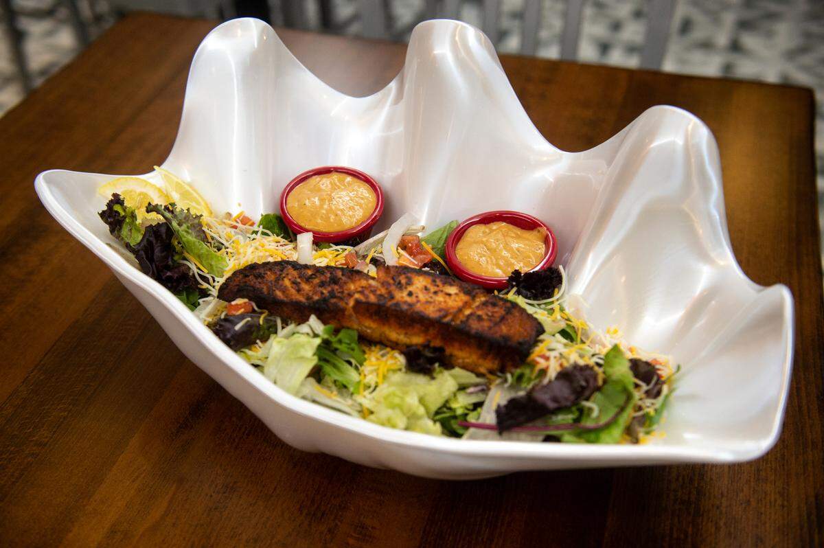 The Char-grilled salmon salad from Port 17 at Harrah’s in Biloxi on Thursday, July 20, 2023.