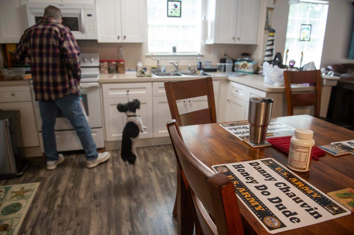Placemats made by a woman who Daniel “Danny” Chauvin, also known as the “Honey Do Dude”, had done free work for sit on Chauvin’s table as he prepares food for his dog Panda at his home in Waveland on Thursday, Jan. 25, 2024.