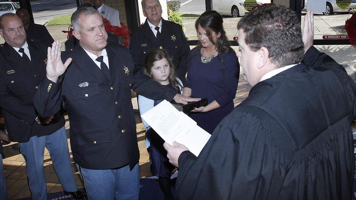 TIM ISBELL/SUN HERALD 
 Troy Peterson is sworn in as Sheriff by Judge Chris Schmidt, Monday, Jan. 4, 2016.