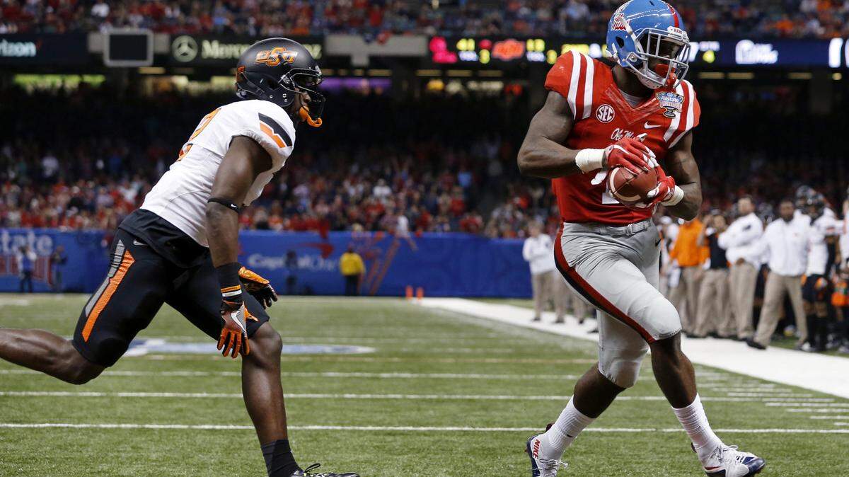 JONATHAN BACHMAN/ASSOCIATED PRESS 
 Ole miss wide receiver Laquon Treadwell (1) scores a touchdown as Oklahoma State cornerback Darius Curry covers in the Sugar Bowl in New Orleans on Jan. 1. Treadwell could become a target for the New Orleans Saints in this year's NFL Draft.