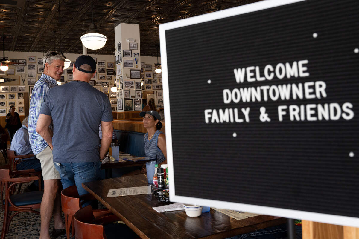 A sign welcoming customers in as owner Robert St. John speaks to customers during the opening day of The Downtowner in Gulfport on Tuesday, June 9, 2026.
