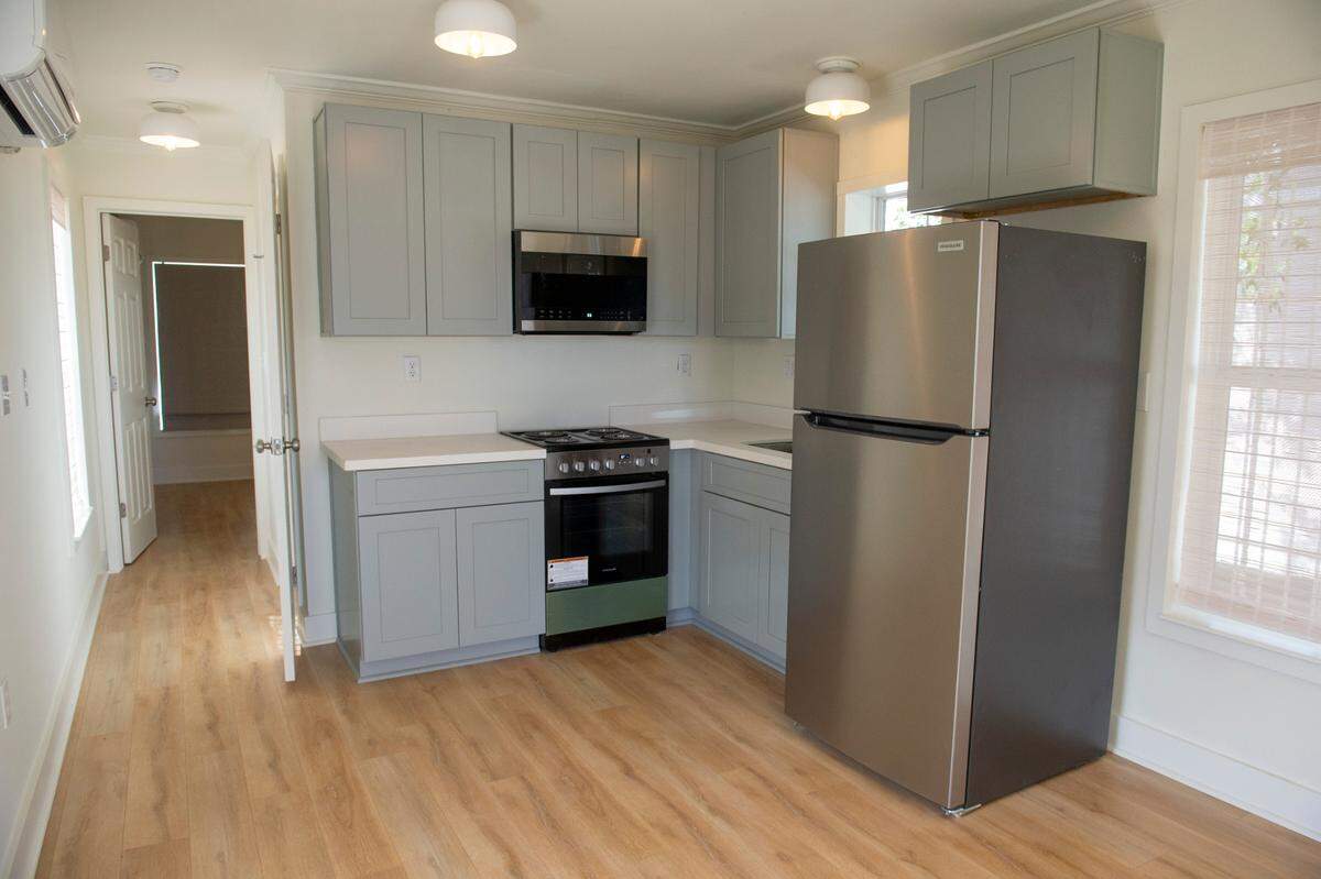 The inside of a one bedroom cottage at the new Cottages at Depot housing development in Pascagoula shows a new kitchen and flooring.