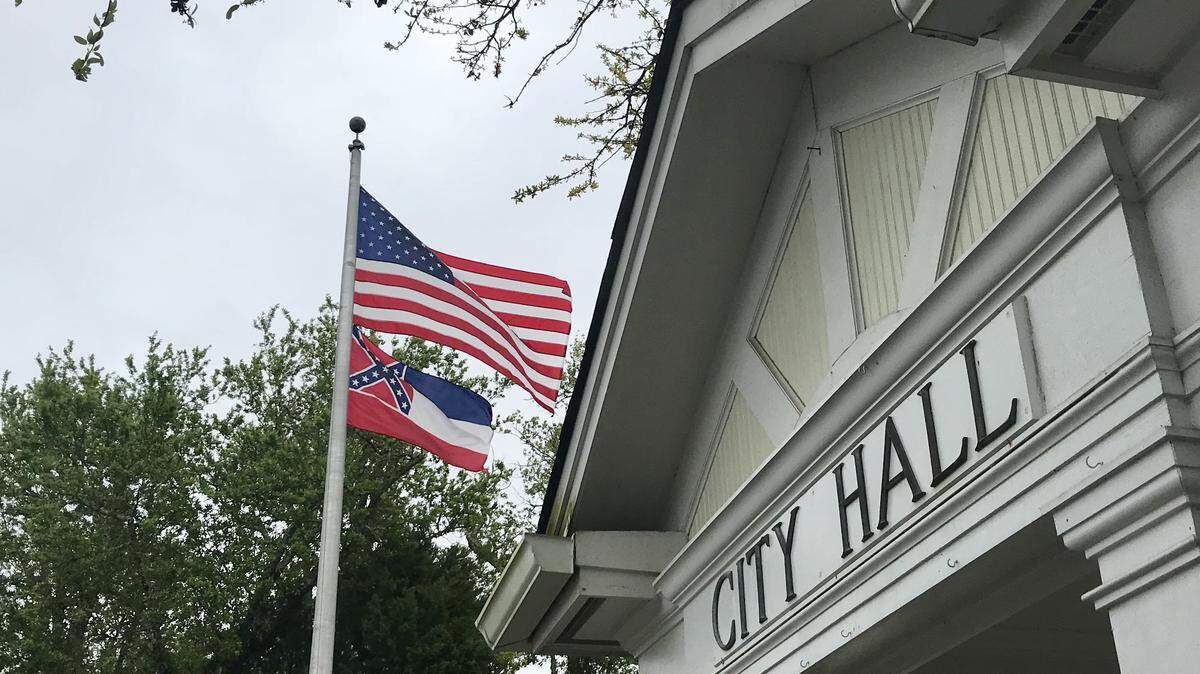 The Mississippi state flag flies with the U.S. flag outside Ocean Springs City Hall.