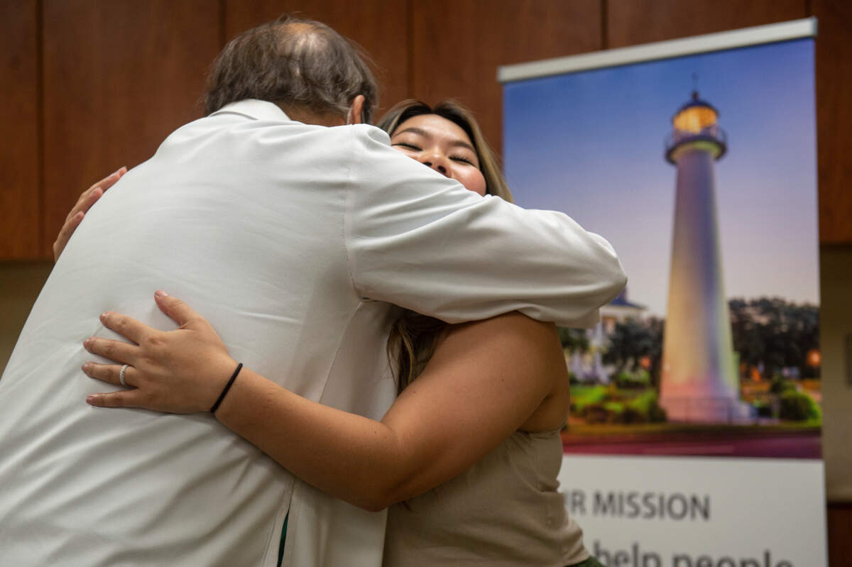 Britney Le, right, hugs Dr. Miguel Melgar after reuniting at Merit Health Hospital in Biloxi on Tuesday, July 26, 2022. Dr. Melgar, a neurological surgeon specializing in minimally invasive surgery for brain tumors, performed surgery on Le in June to remove a tumor on her pituitary gland that was affecting her vision.