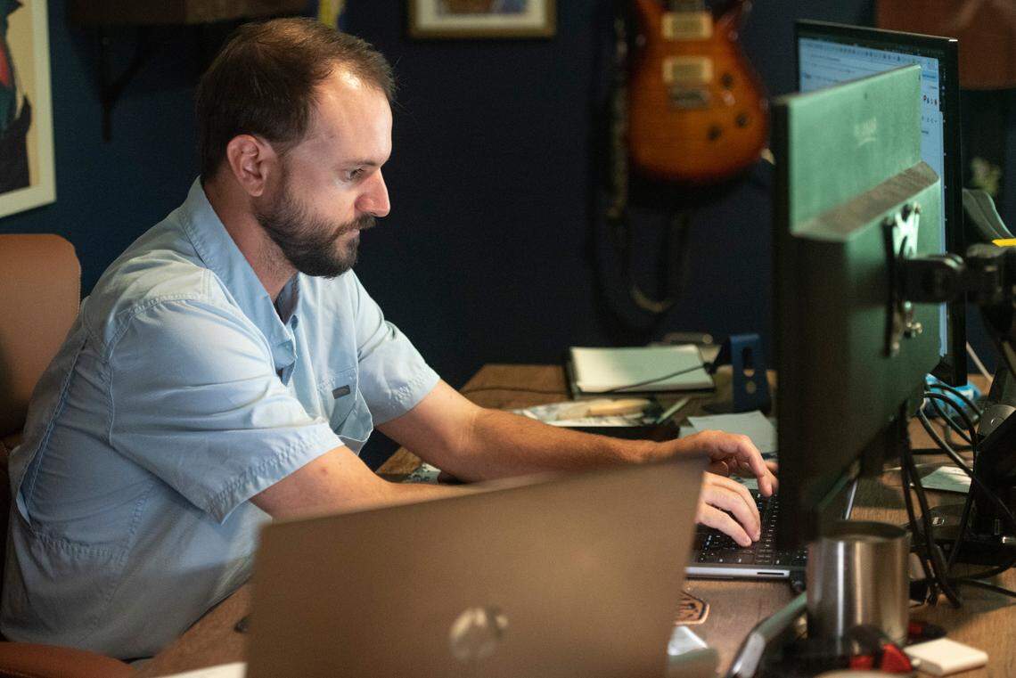 Christian Braswell works at his home office in Gulfport on Friday, May 23, 2025. Remote work allowed Braswell, who works remotely doing web development for a company called Fruition, to move back to Mississippi from Colorado with his wife.