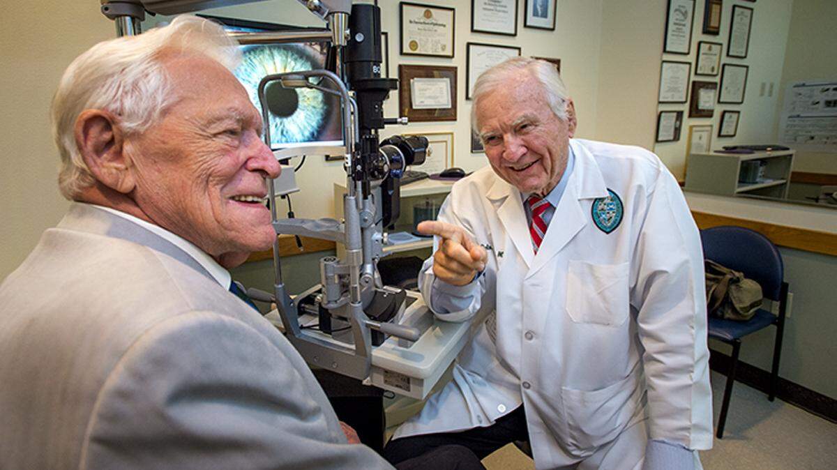COURTESY TULANE UNIVERSITYJohn Young sits with Dr. Delmar Caldwell, who performed surgery on Young's cornea in 2014 that restored his vision.