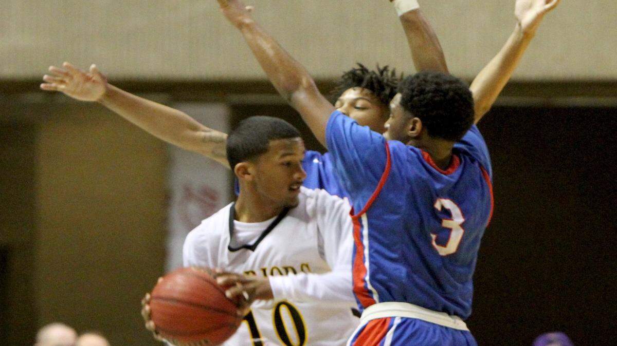 JOHN FITZHUGH/SUN HERALD 
 Pascagoula's Noel Jones and Darius Johnson(3) trap D'Iberville's Nick Jenkins during the second quarter of their Hoopsfest game at the Mississippi Coast Coliseum in Biloxi on Saturday Jan. 30, 2016.